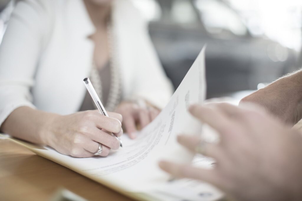 Person signing a representation agreement with a client